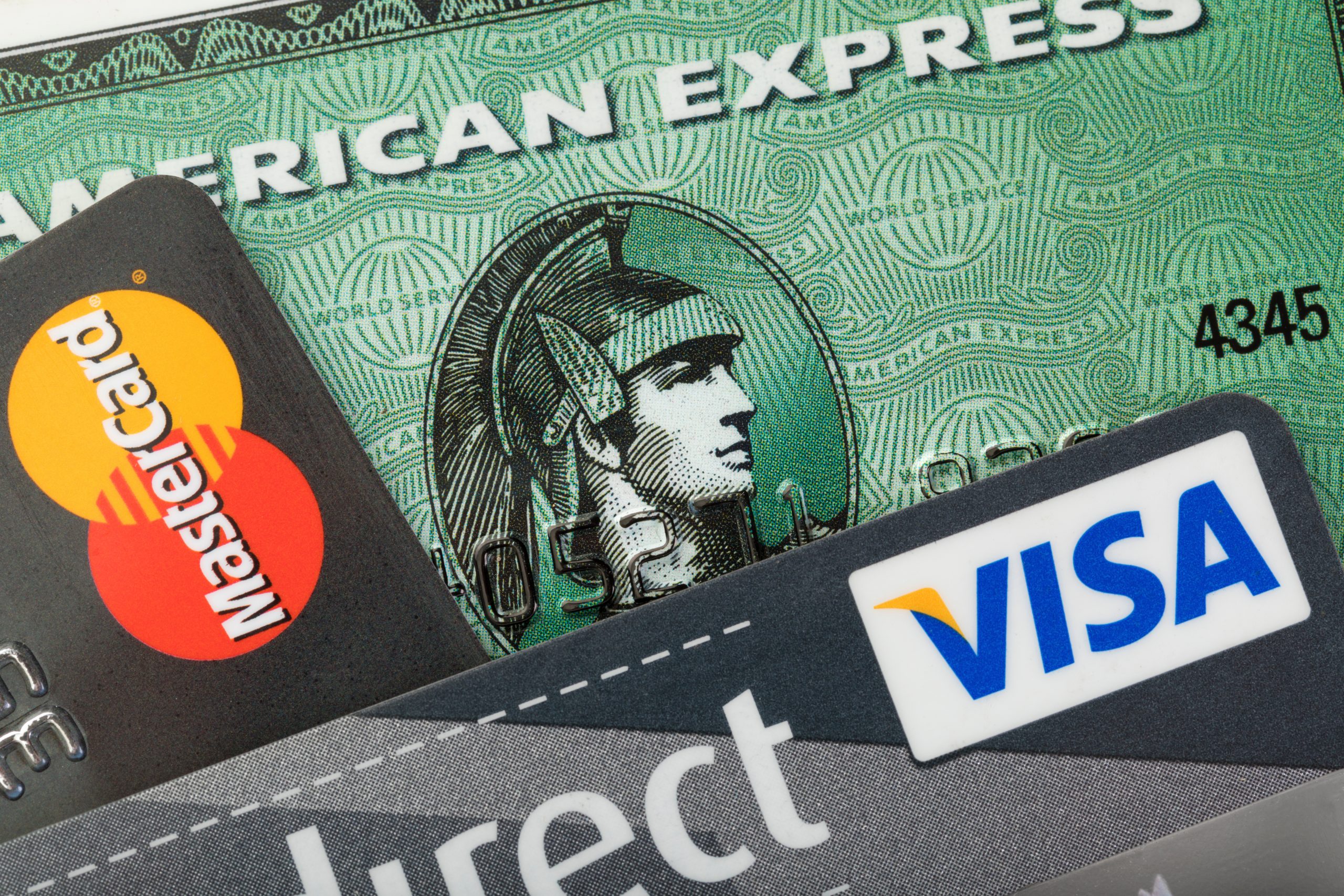 Stade, Germany - September 4, 2019: Closeup studio shot of credit cards issued by the three major brands American Express, VISA and MasterCard.