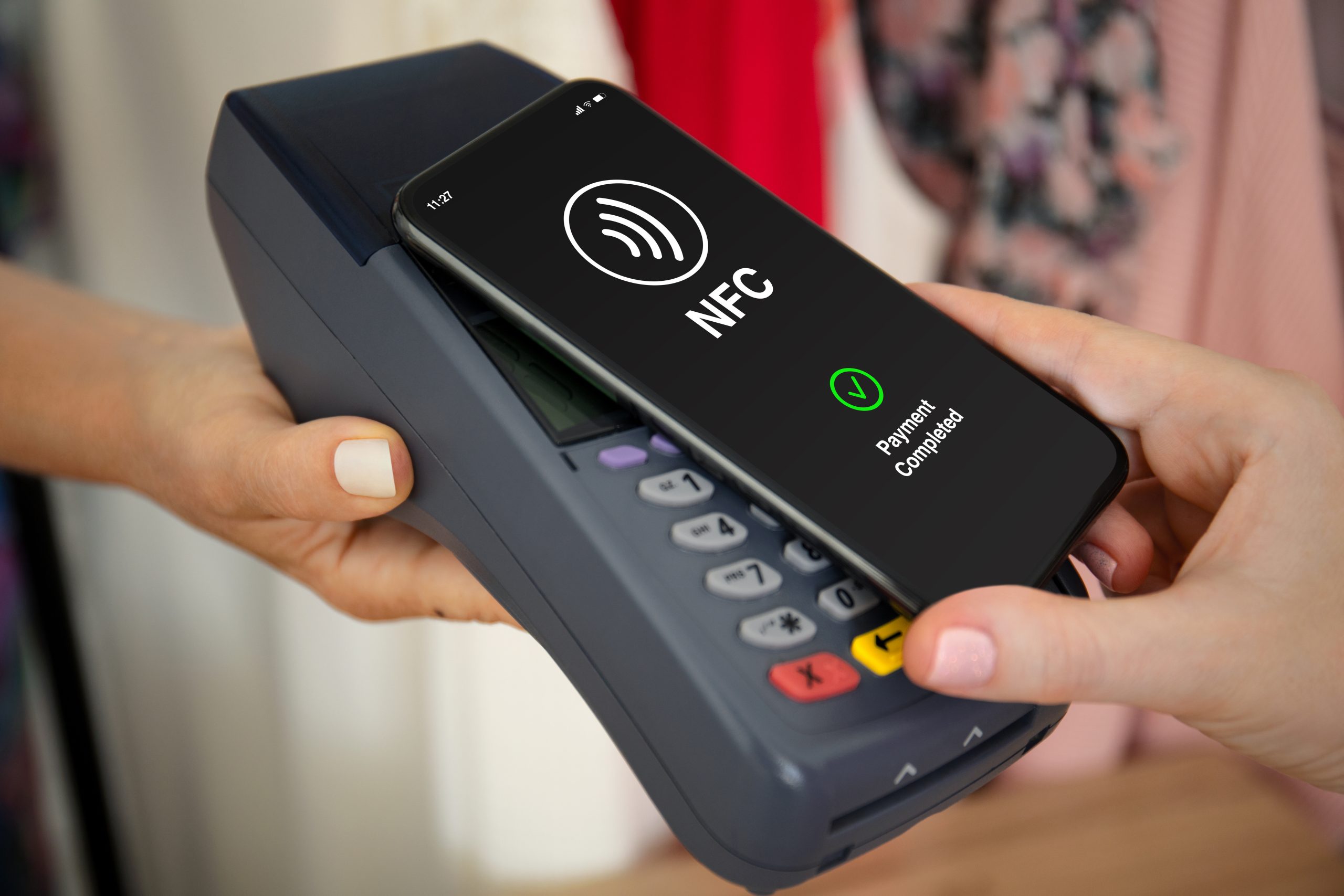 Female hands phone pay wireless technology nfc via pos terminal